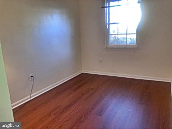 14909 Cleese Court, Unit 4CA Silver Spring, MD 20906 - Photo 28 of 43 an empty room with wooden floor and windows