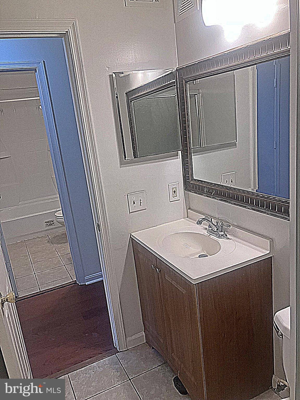 14909 Cleese Court, Unit 4CA Silver Spring, MD 20906 - Photo 31 of 43 a bathroom with a sink and a mirror