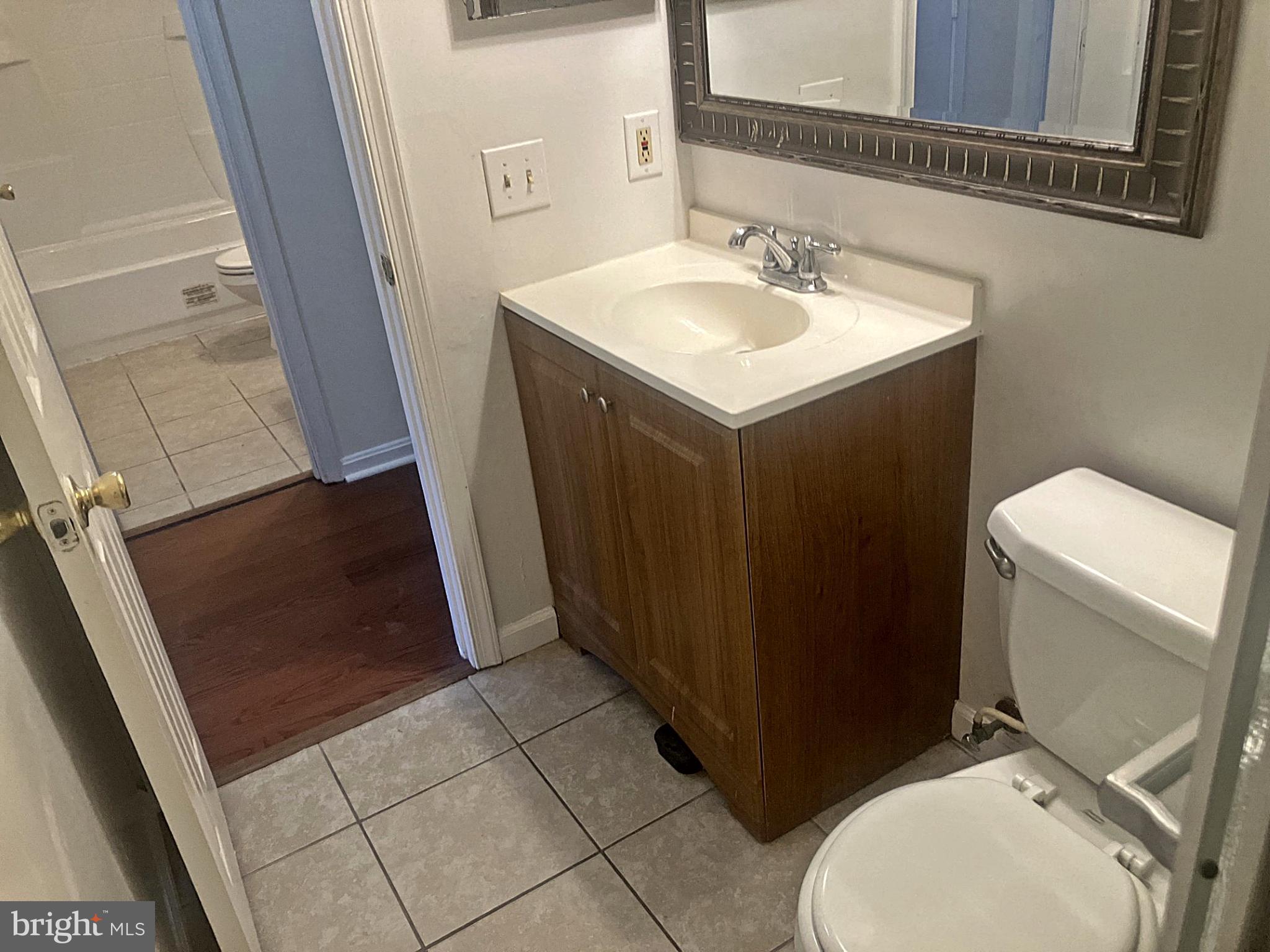 14909 Cleese Court, Unit 4CA Silver Spring, MD 20906 - Photo 32 of 43 a bathroom with a sink a toilet and a mirror