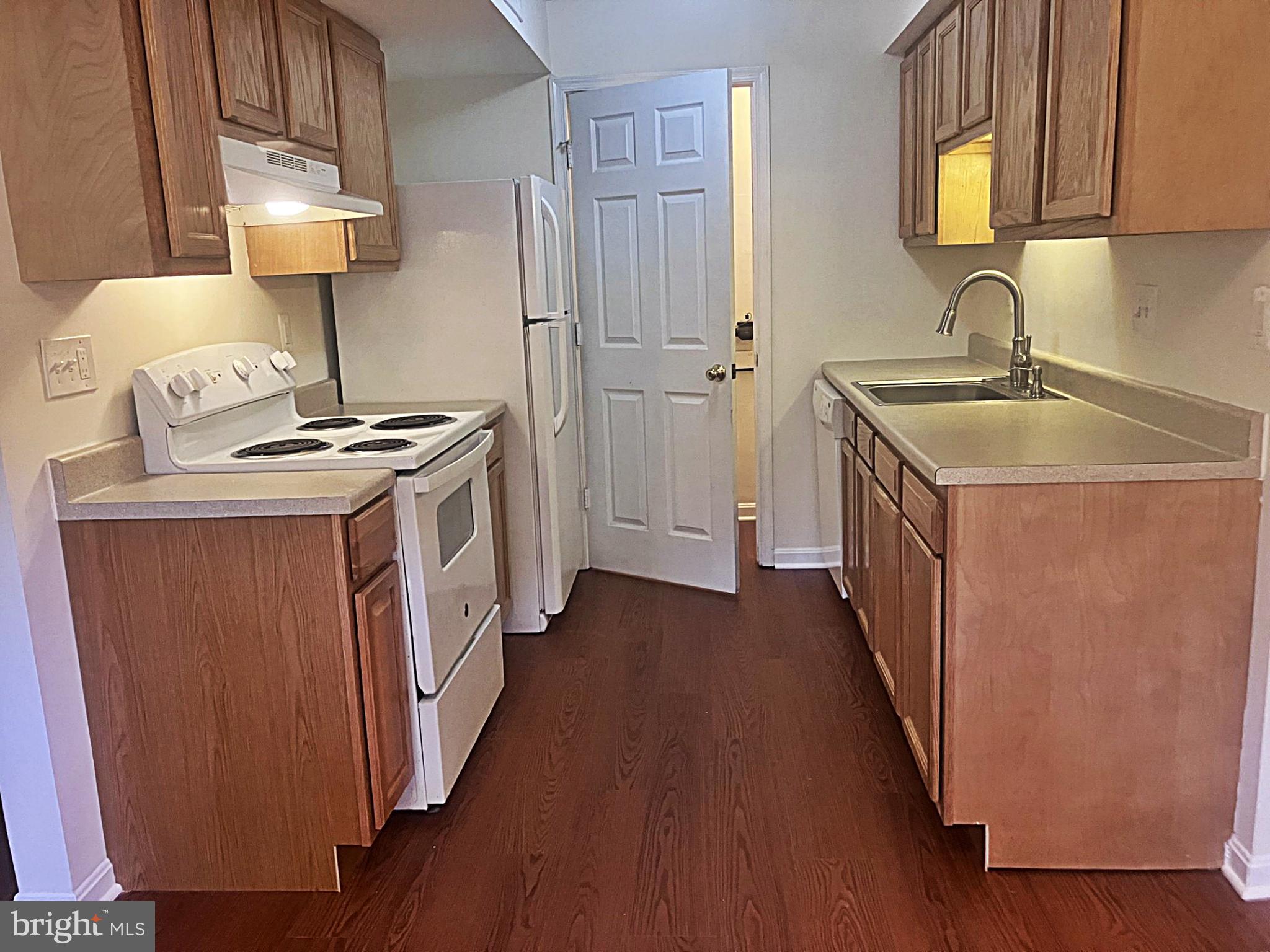 14909 Cleese Court, Unit 4CA Silver Spring, MD 20906 - Photo 8 of 43 a kitchen with a stove a sink and a refrigerator