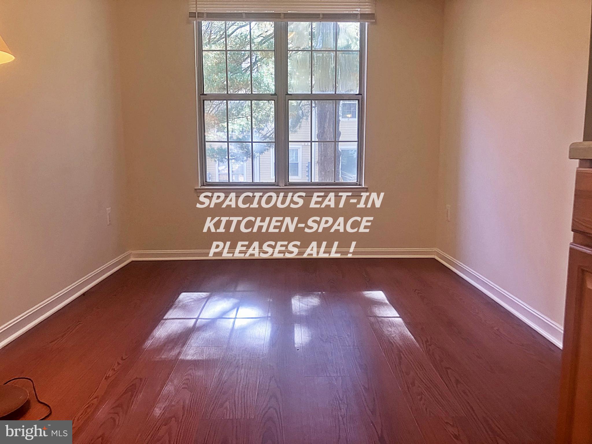 14909 Cleese Court, Unit 4CA Silver Spring, MD 20906 - Photo 9 of 43 a view of an empty room with wooden floor and a window