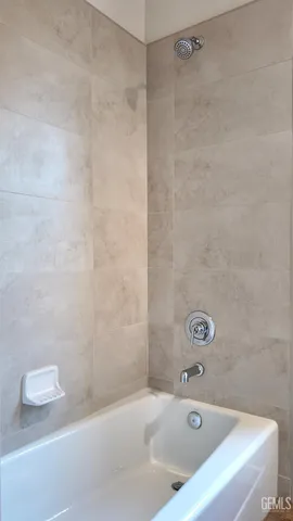 a bathroom with a bathtub and a shower