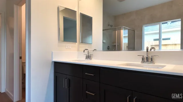 a bathroom with a double vanity sink and a mirror