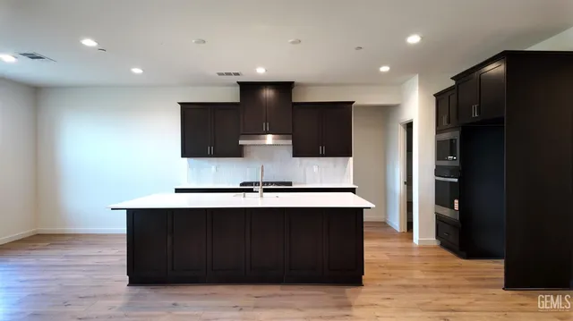 a kitchen with stainless steel appliances a sink stove and refrigerator