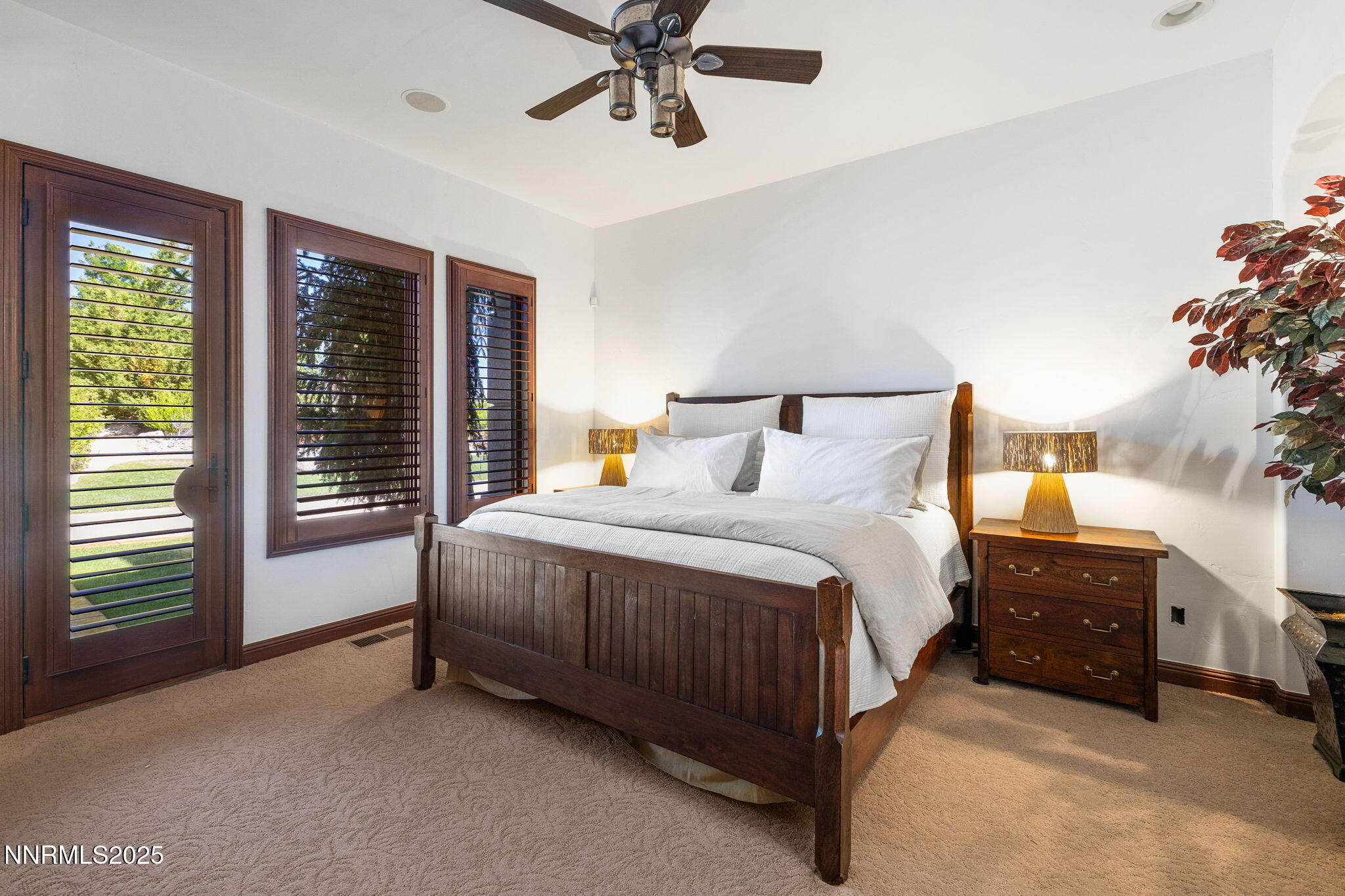 12900 Silver Wolf Road Reno, NV 89511 - Photo 13 of 51 a spacious bedroom with a bed and a chandelier