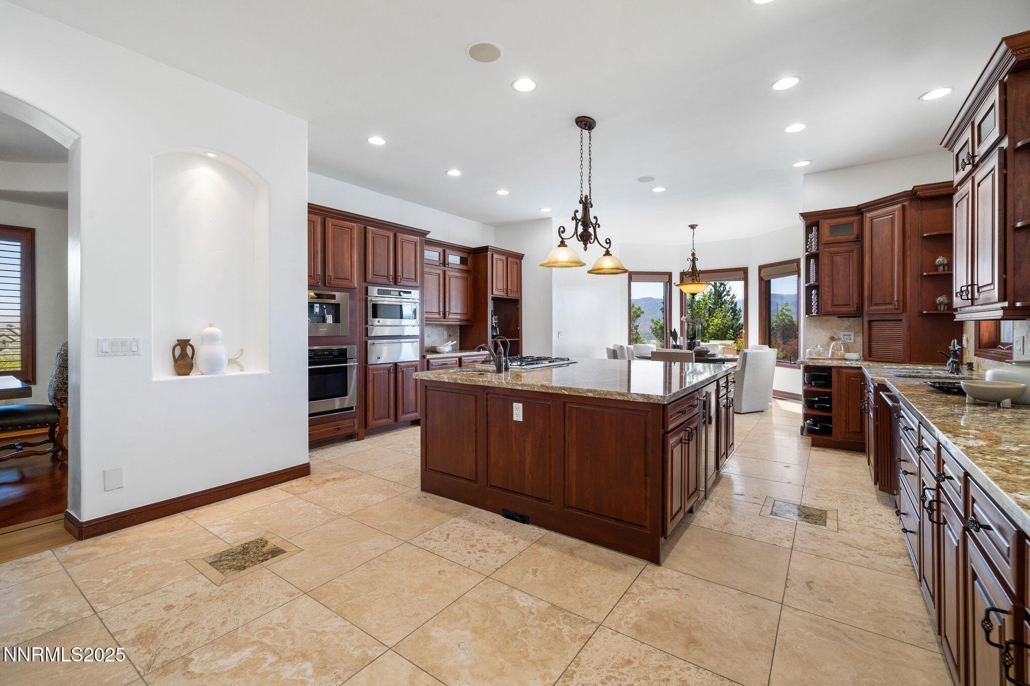 12900 Silver Wolf Road Reno, NV 89511 - Photo 18 of 51 a large kitchen with stainless steel appliances kitchen island granite countertop a large counter top and a stove top oven