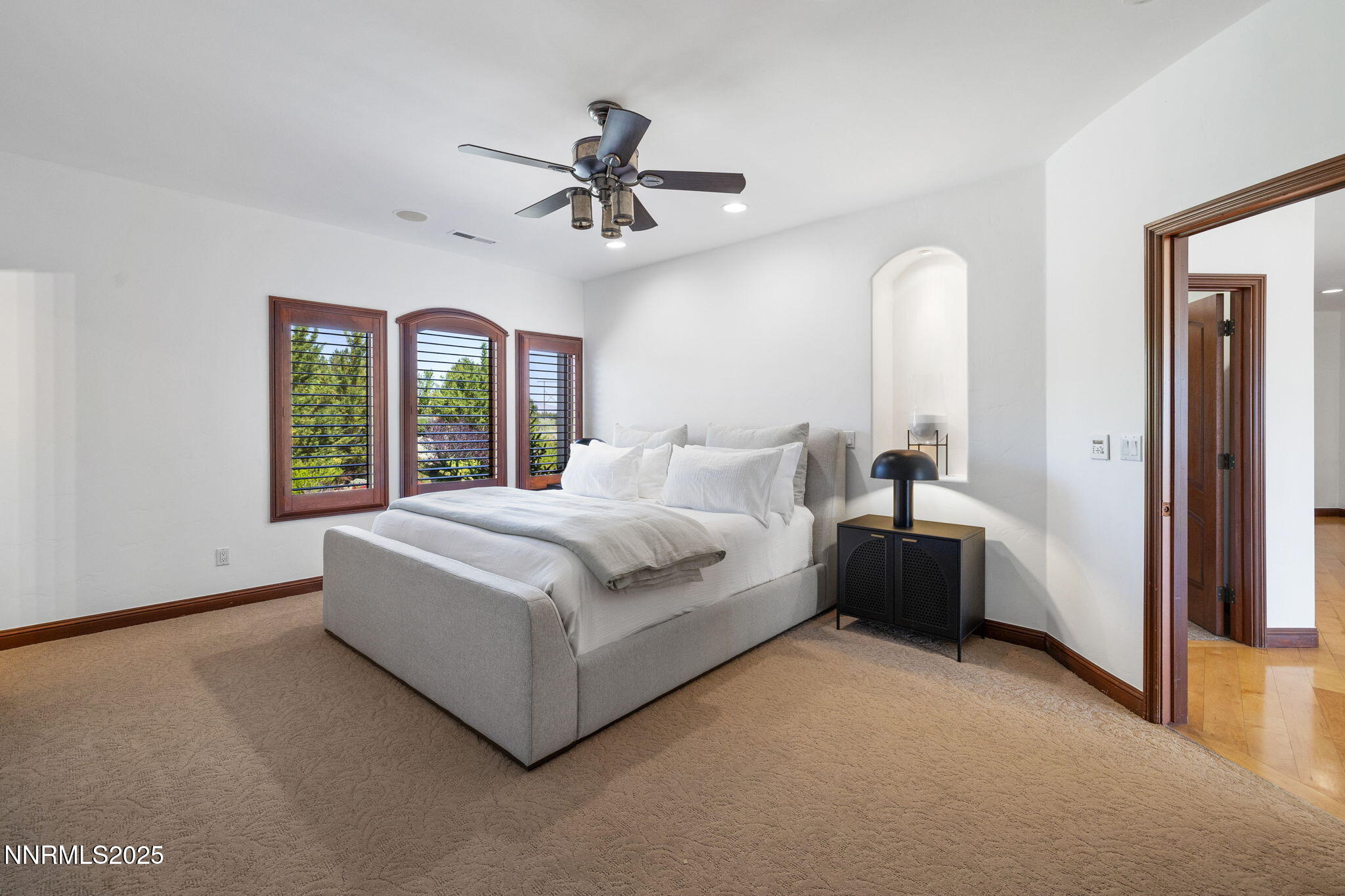 12900 Silver Wolf Road Reno, NV 89511 - Photo 20 of 51 a spacious bedroom with a large bed and a chandelier