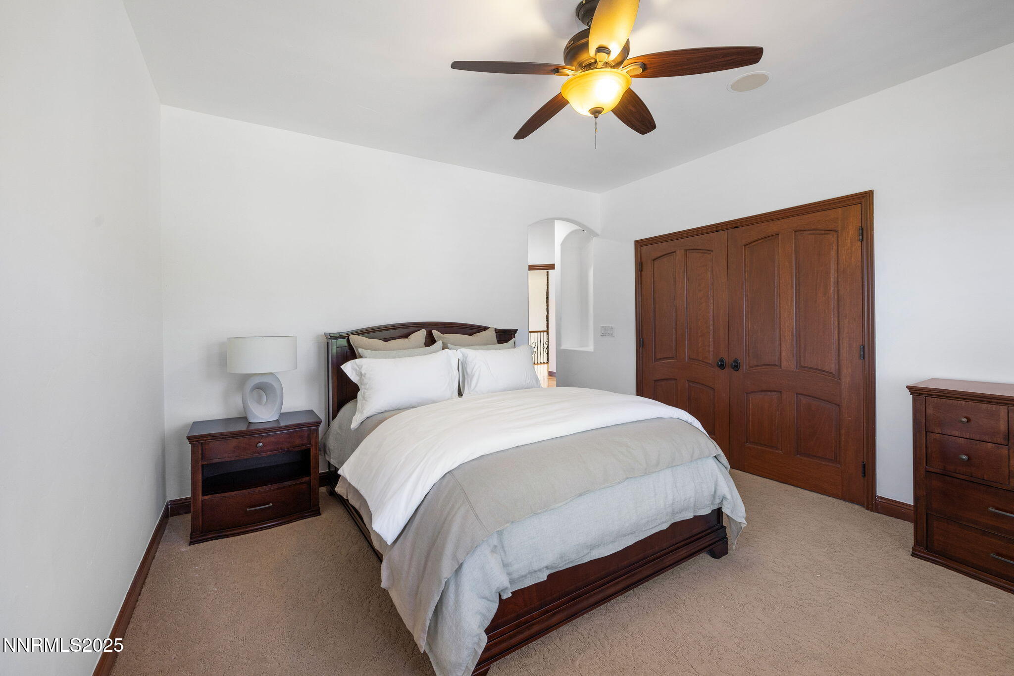 12900 Silver Wolf Road Reno, NV 89511 - Photo 22 of 51 a bedroom with a bed and a chandelier