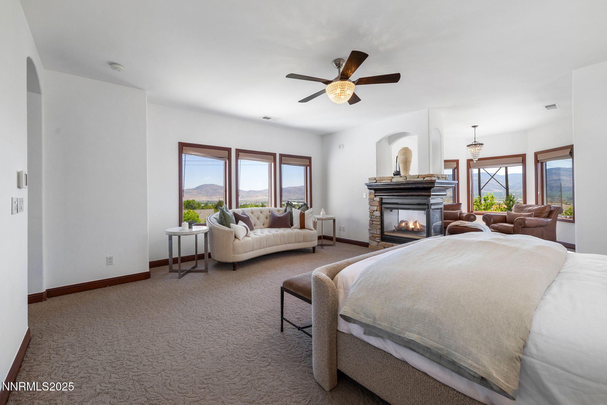 12900 Silver Wolf Road Reno, NV 89511 - Photo 27 of 51 a spacious bedroom with a bed and a chandelier