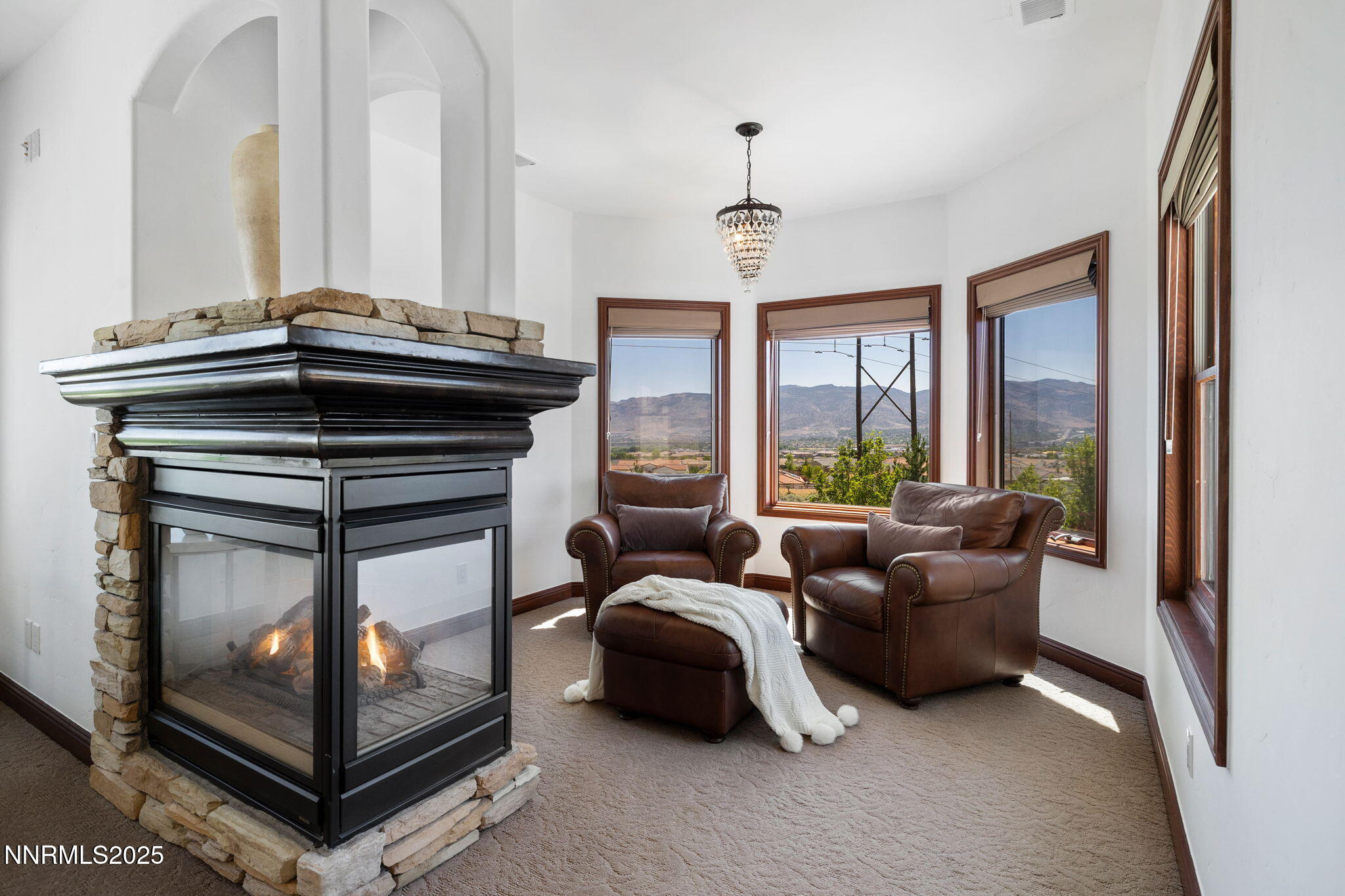 12900 Silver Wolf Road Reno, NV 89511 - Photo 28 of 51 a living room with furniture a flat screen tv and a floor to ceiling window