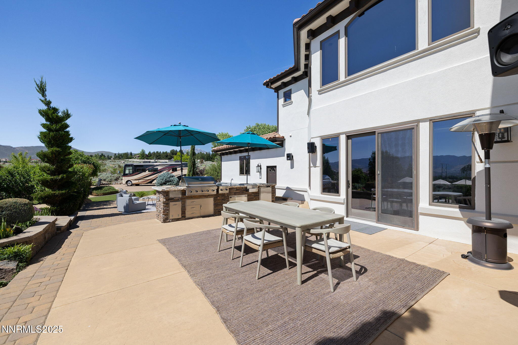 12900 Silver Wolf Road Reno, NV 89511 - Photo 31 of 51 a view of a patio with table and chairs potted plants with wooden floor