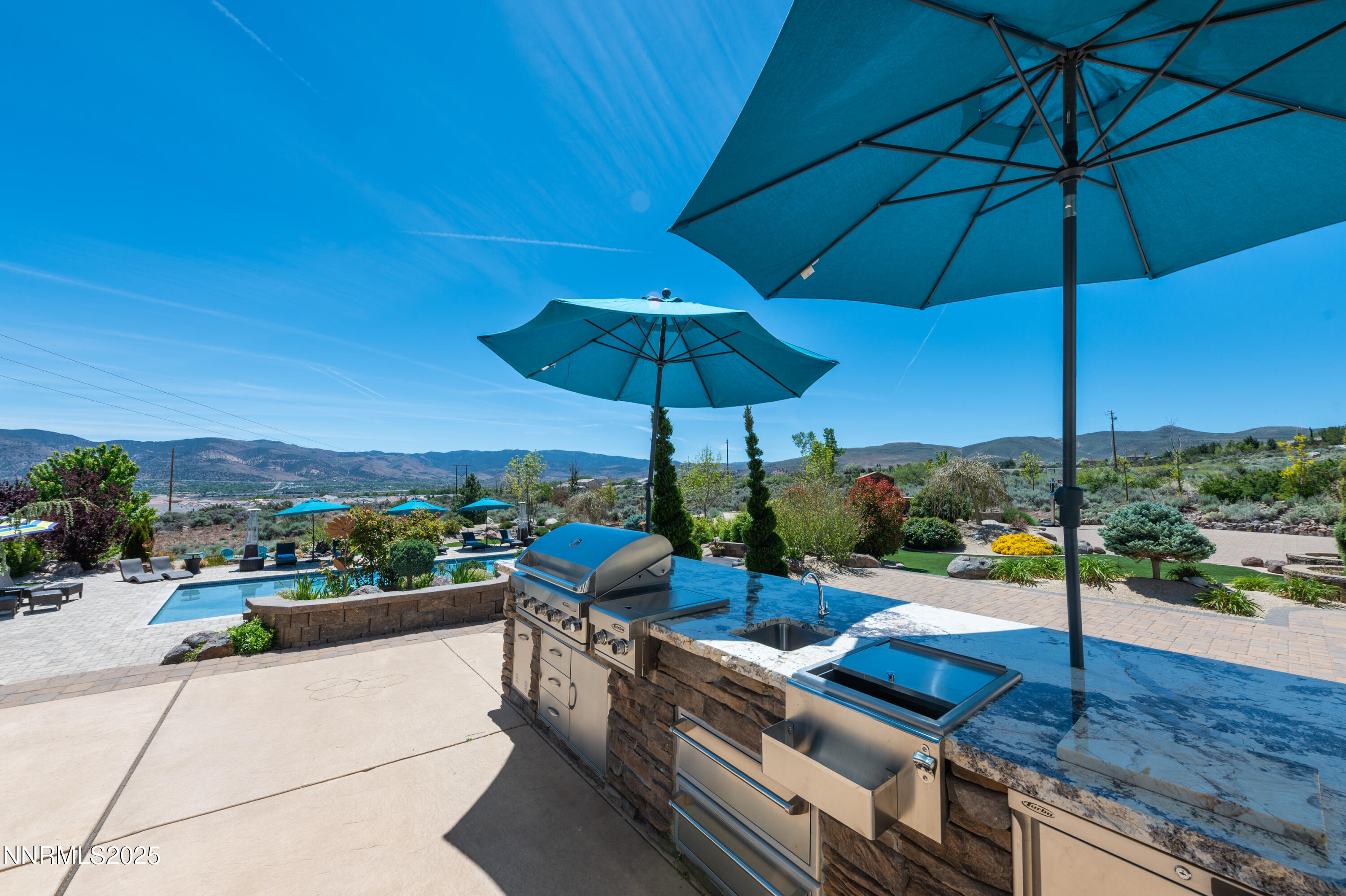 12900 Silver Wolf Road Reno, NV 89511 - Photo 32 of 51 a view of a floor with a table and chairs under an umbrella