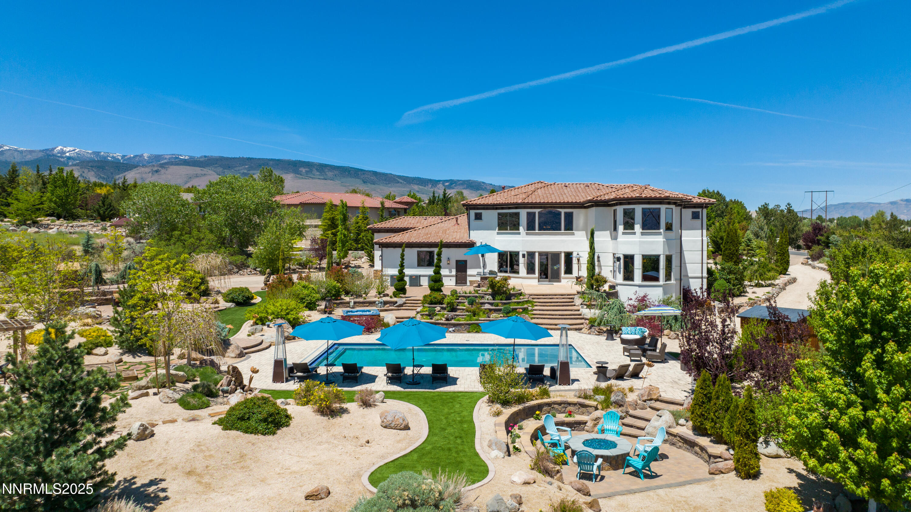 12900 Silver Wolf Road Reno, NV 89511 - Photo 43 of 51 a view of a patio with couches table and chairs under an umbrella
