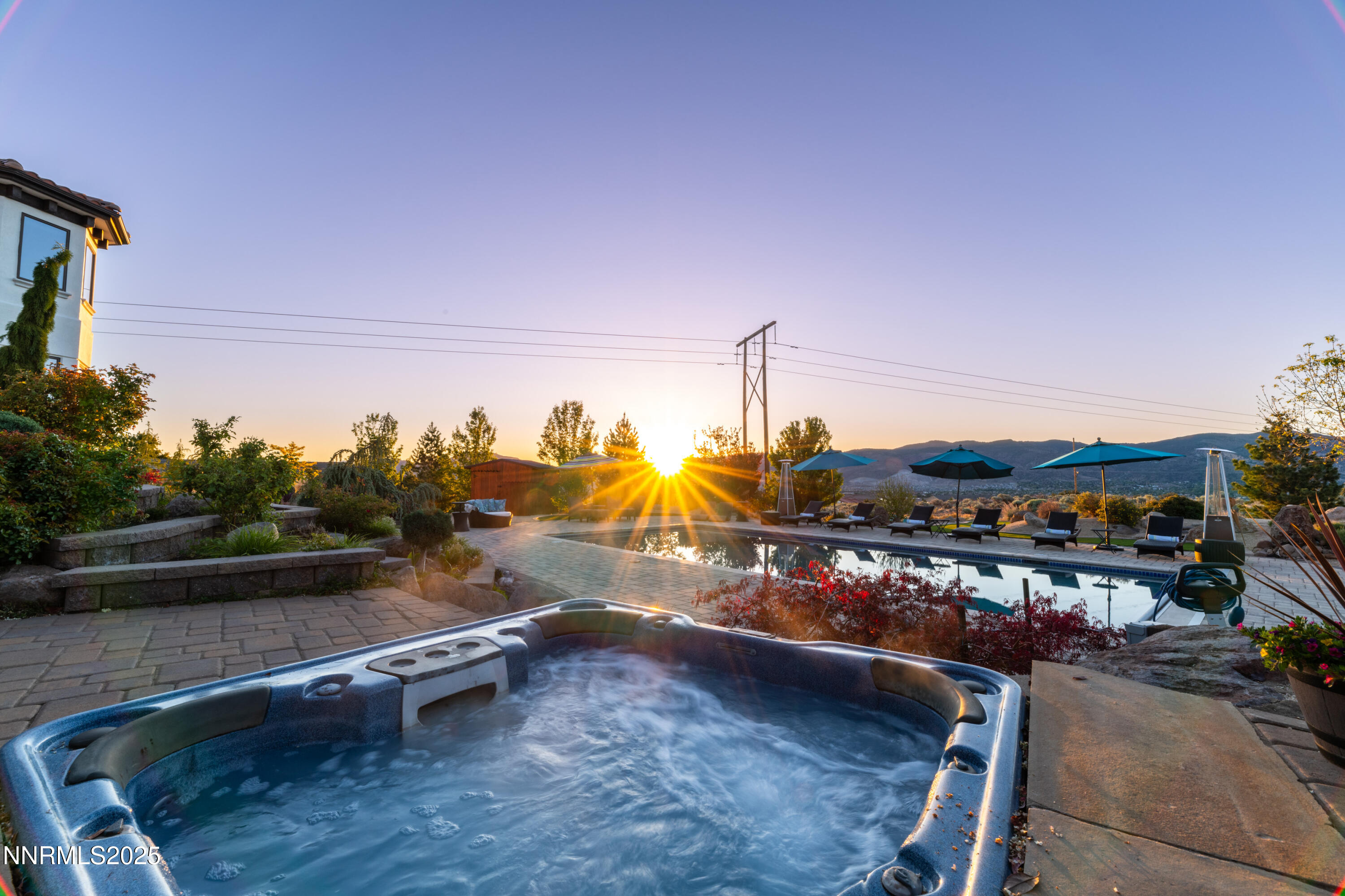 12900 Silver Wolf Road Reno, NV 89511 - Photo 46 of 51 a view of a lake with a table and chairs on the roof deck