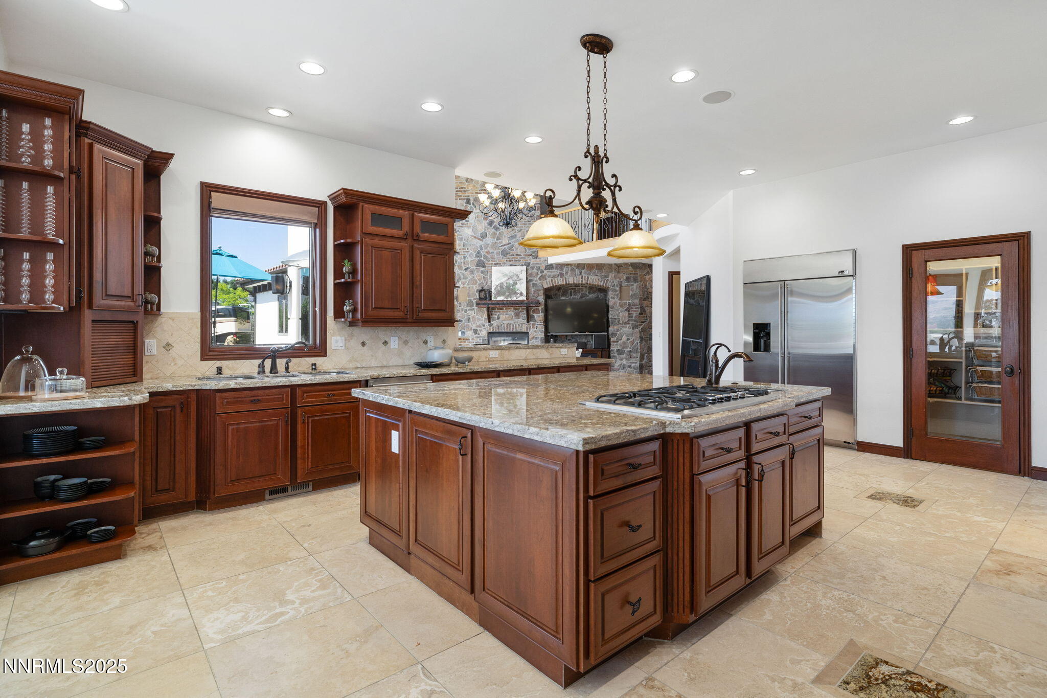 12900 Silver Wolf Road Reno, NV 89511 - Photo 5 of 51 a kitchen with kitchen island granite countertop a stove and a sink