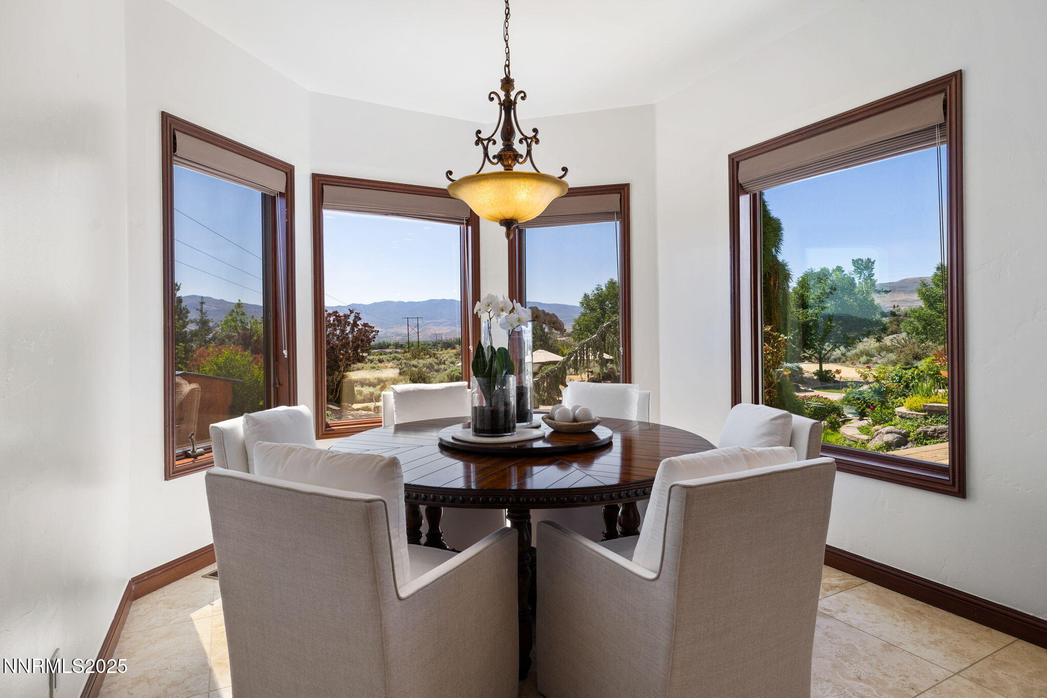 12900 Silver Wolf Road Reno, NV 89511 - Photo 6 of 51 a dining room with furniture a chandelier and wooden floor