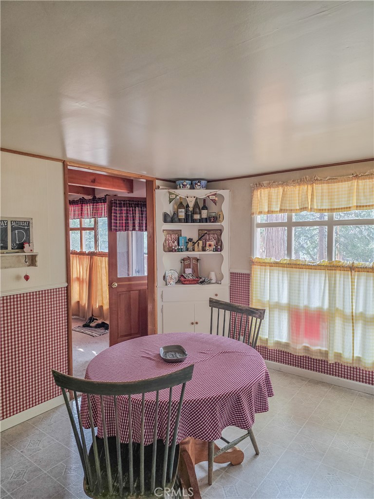 52745 Sylvan Way Idyllwild, CA 92549 - Photo 15 of 31 a bedroom with a bed a dresser and a large window