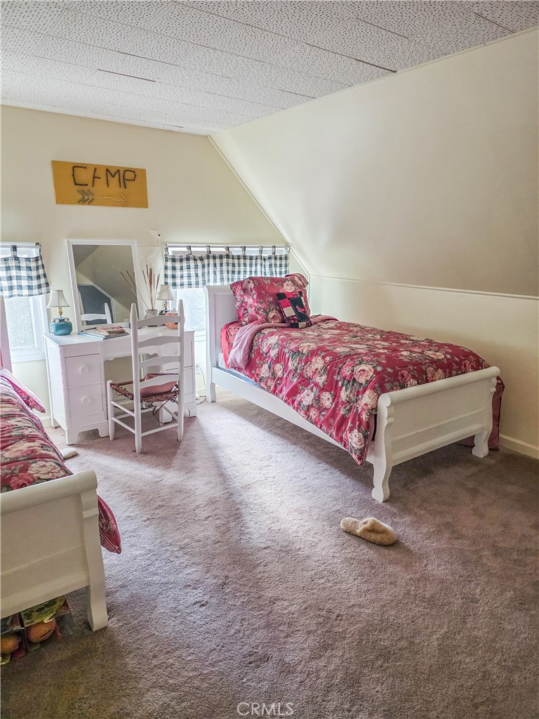 52745 Sylvan Way Idyllwild, CA 92549 - Photo 16 of 31 a bedroom with a bed and a chair