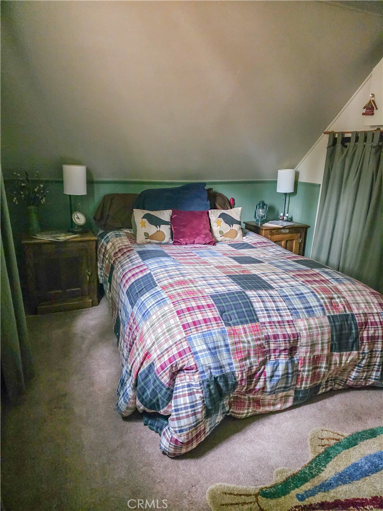 52745 Sylvan Way Idyllwild, CA 92549 - Photo 19 of 31 a bedroom with a bed and a potted plant