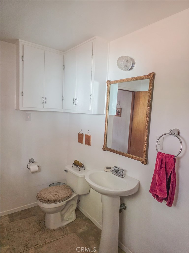 52745 Sylvan Way Idyllwild, CA 92549 - Photo 25 of 31 a bathroom with a toilet sink and mirror