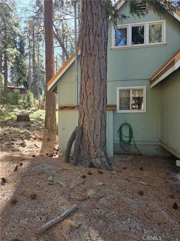 a view of a house with a yard and wooden fence