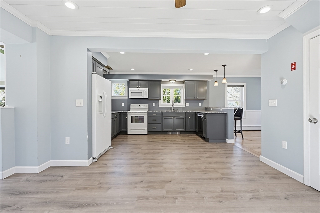 44 Clark Street Spencer, MA 01562 - Photo 14 of 41 a large kitchen with a center island and stainless steel appliances