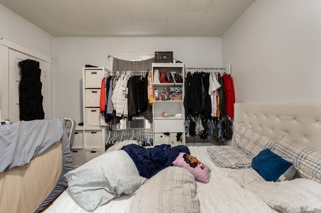 7 Mott Street Worcester, MA 01604 - Photo 16 of 20 a bedroom with a bed and a mirror