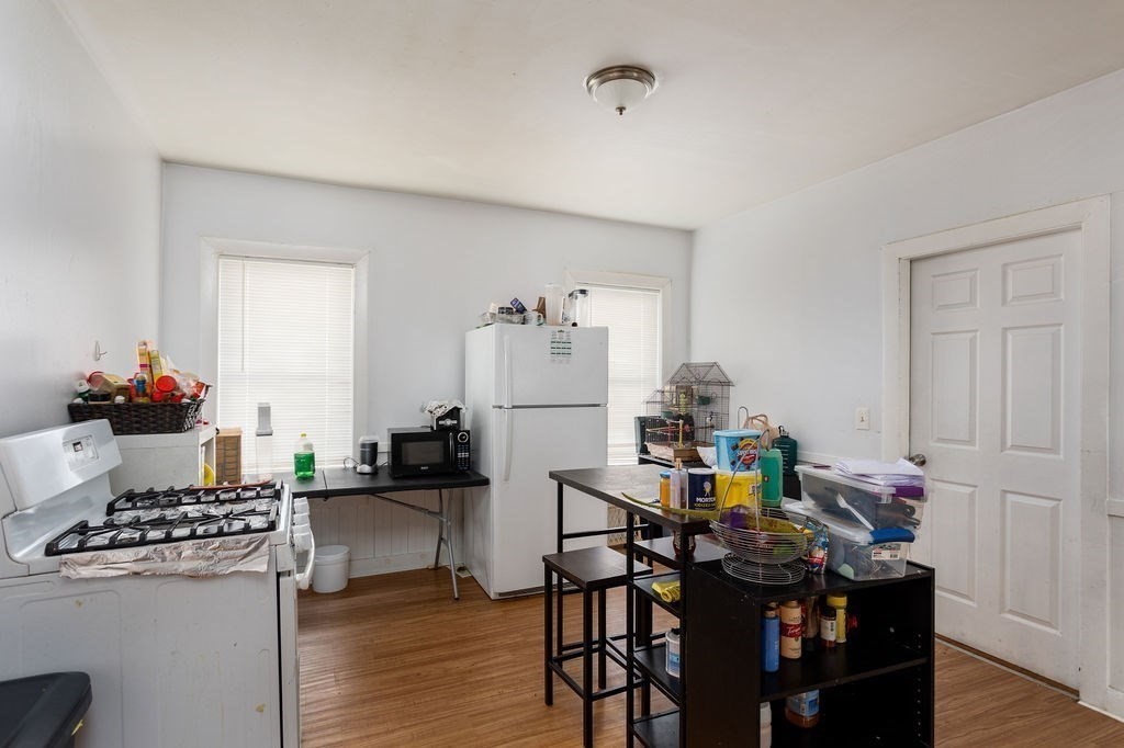 7 Mott Street Worcester, MA 01604 - Photo 19 of 20 a living room with dining table and a refrigerator