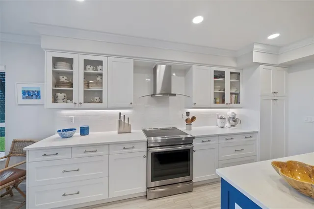 a kitchen with white cabinets and white appliances