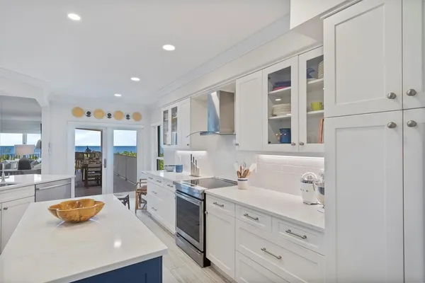 a large white kitchen with cabinets