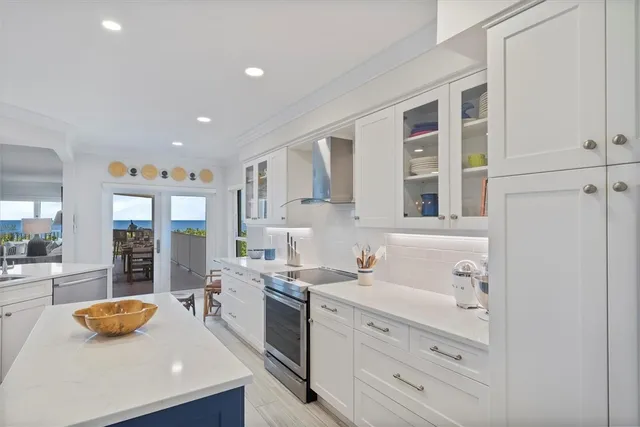 a large white kitchen with cabinets
