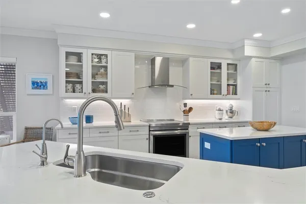 a kitchen with stainless steel appliances granite countertop a sink stove and cabinets