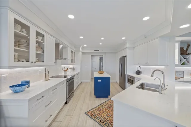 a large kitchen with stainless steel appliances lots of counter top space