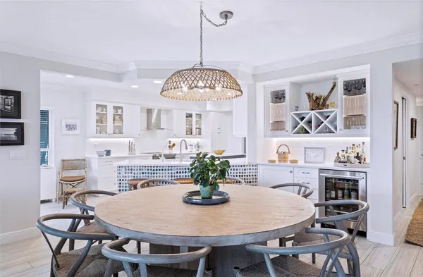 a view of a dining room with furniture a chandelier and wooden floor