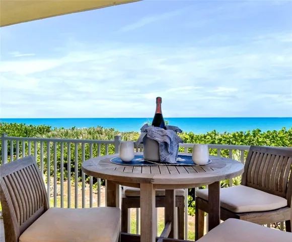 a view of a balcony with furniture and city view
