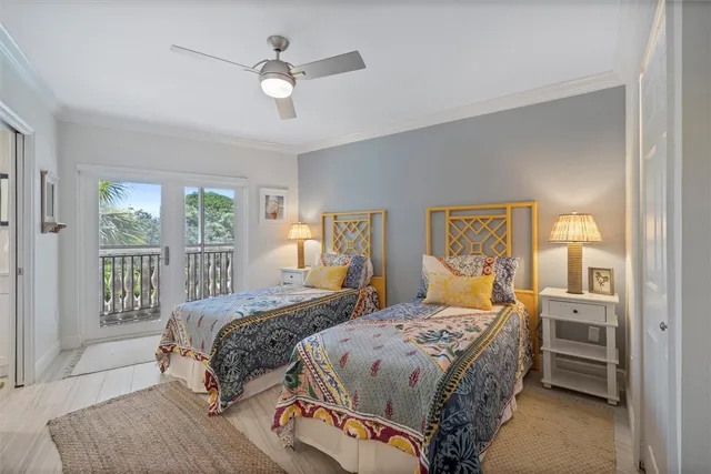 a bedroom with a large bed and a chandelier fan