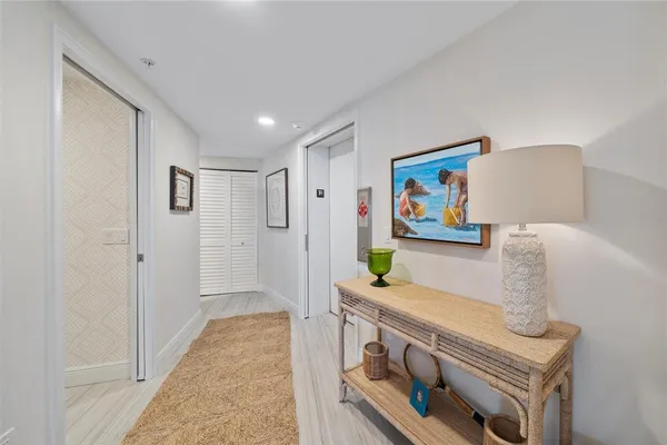 a view of hallway with painting and furniture