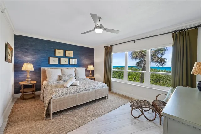 a bedroom with a large bed and a large window