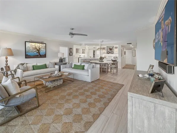 a living room with furniture and a kitchen