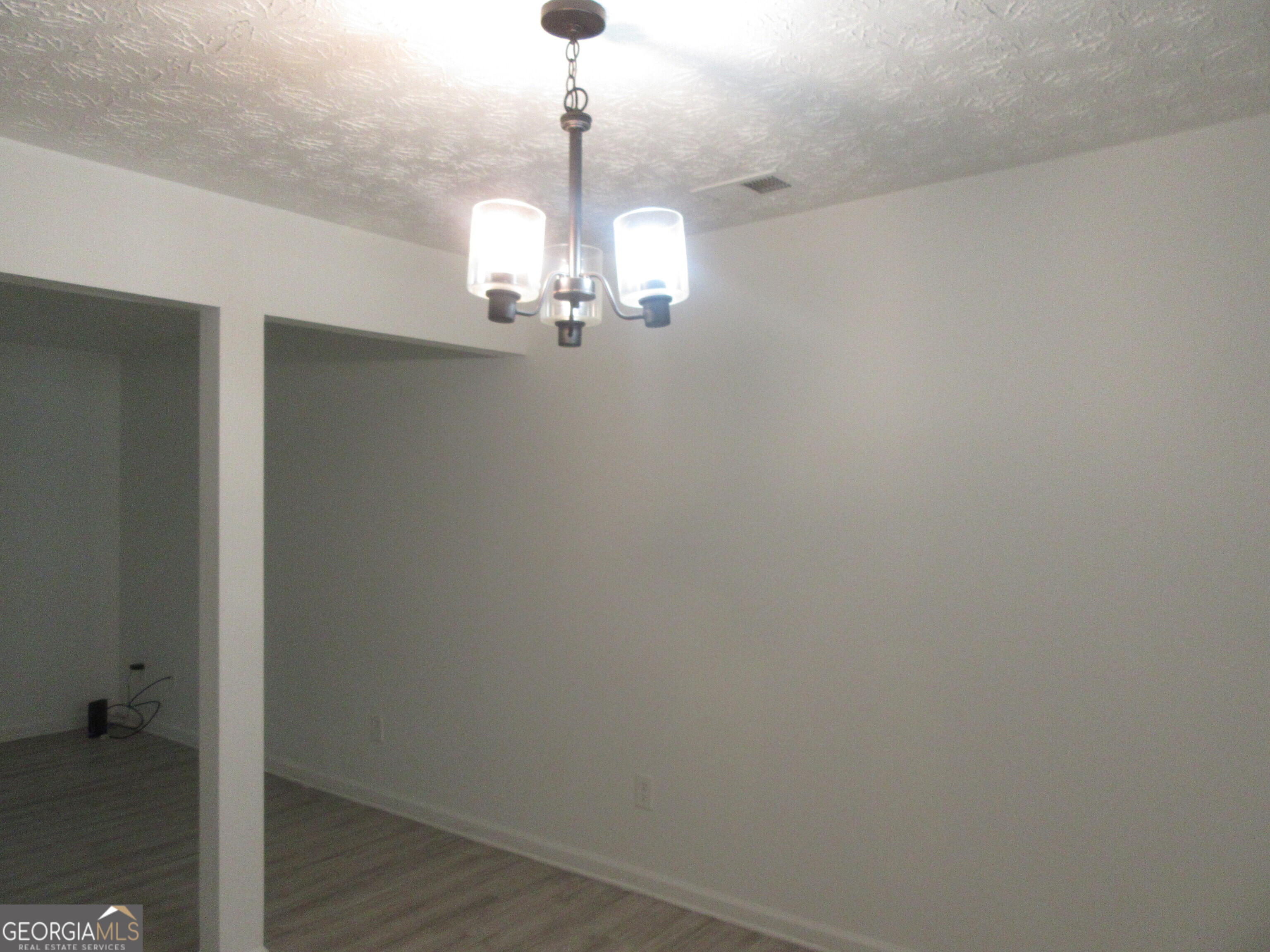 3548 Waldrop Trail Decatur, GA 30034 - Photo 15 of 38 a view of a chandelier and a wooden floor in a room