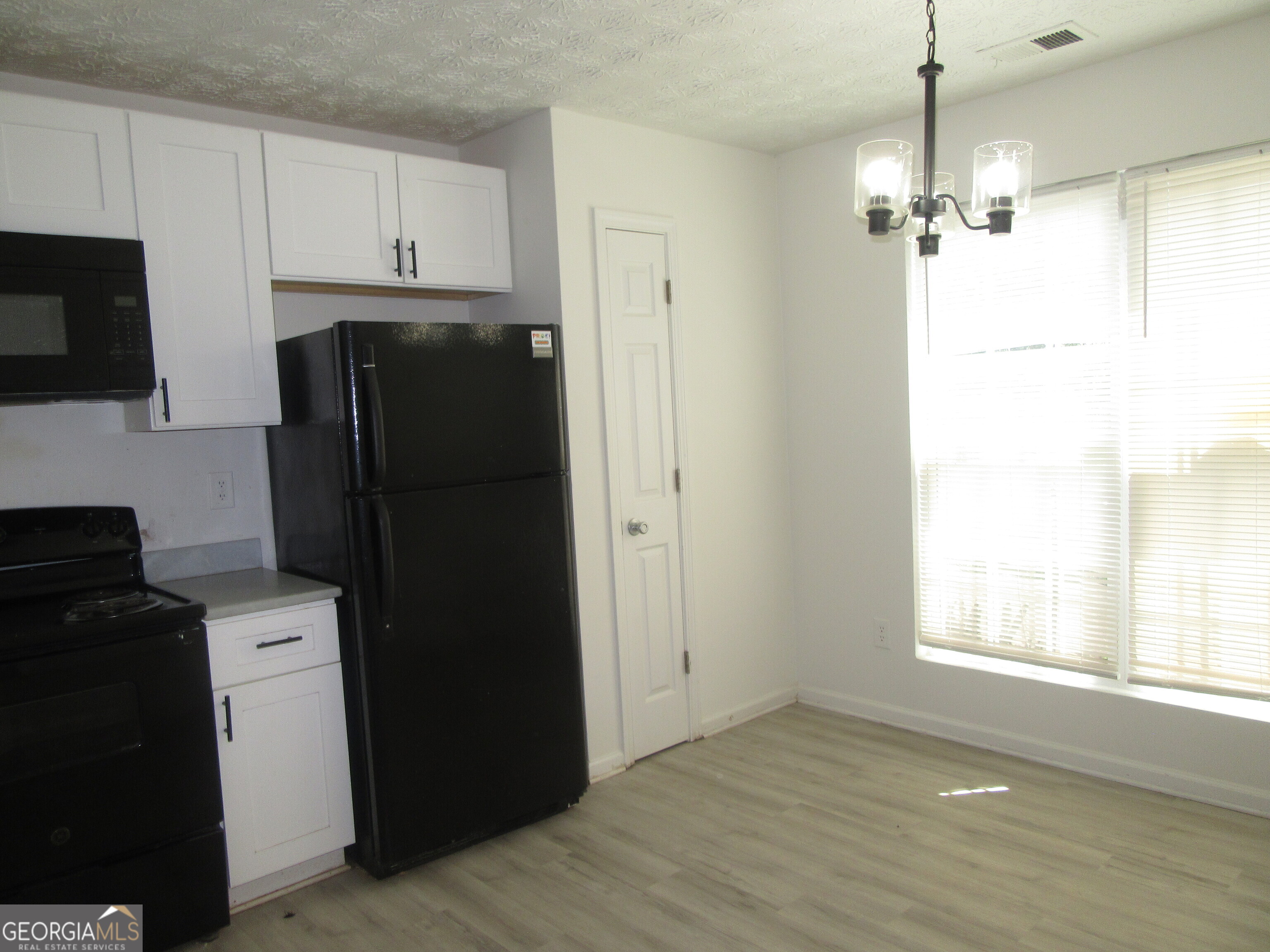 3548 Waldrop Trail Decatur, GA 30034 - Photo 6 of 38 a kitchen with a refrigerator a stove a microwave and cabinets