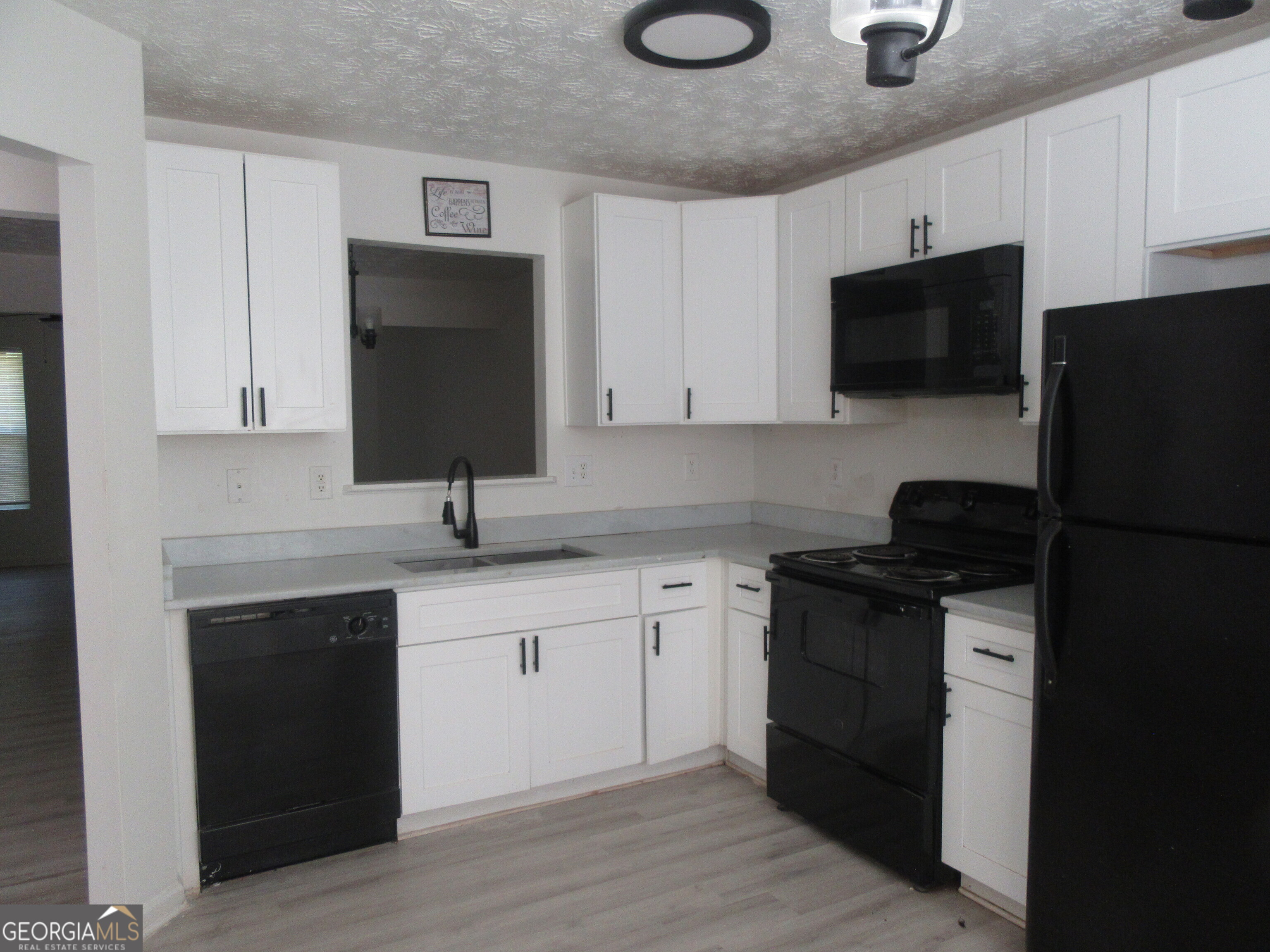 3548 Waldrop Trail Decatur, GA 30034 - Photo 7 of 38 a kitchen with a sink stainless steel appliances and cabinets