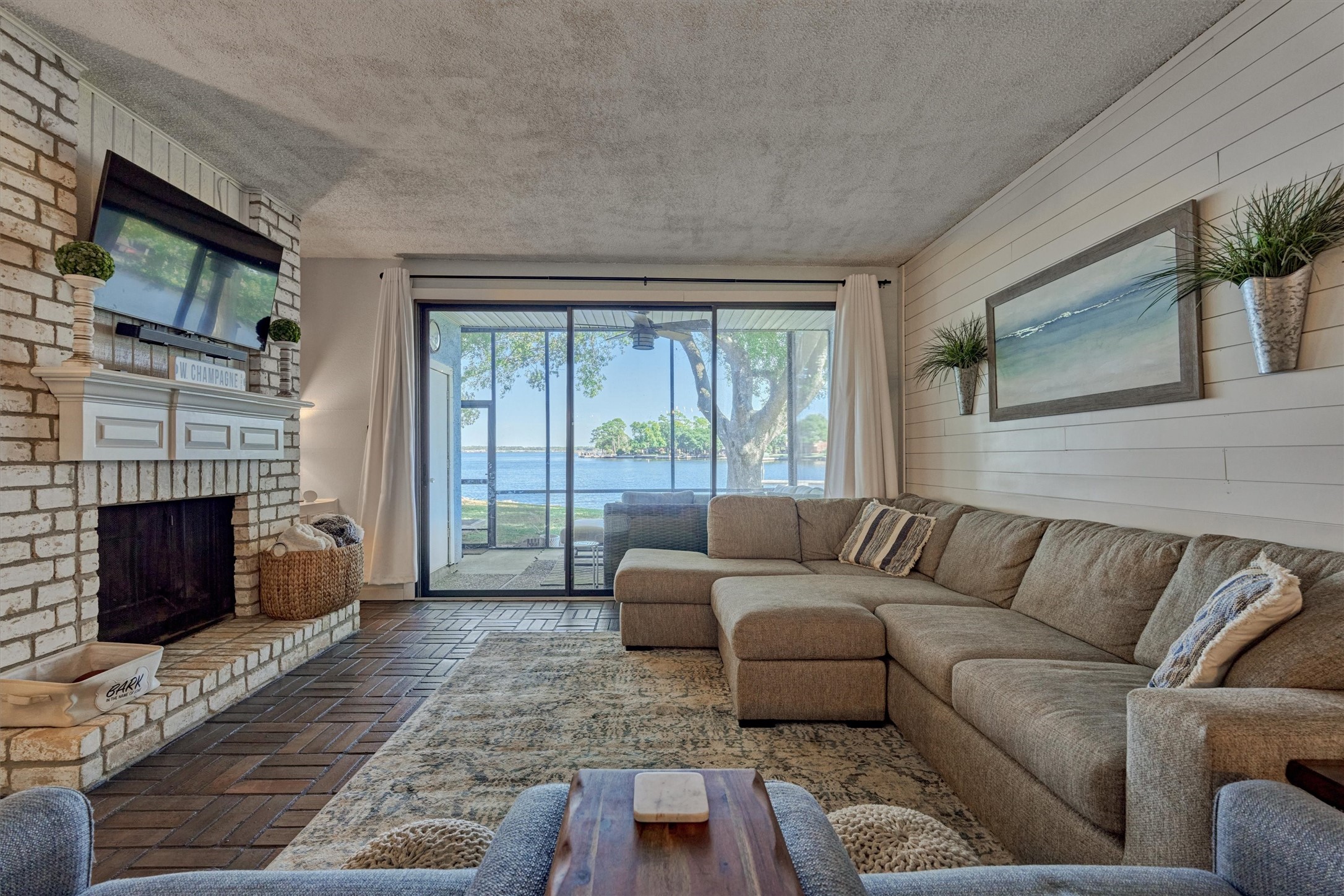 1428 Bowsprit Point Willis, TX 77318 - Photo 1 of 47 A wall of windows and sliding glass door provide expansive views of the lake beyond.