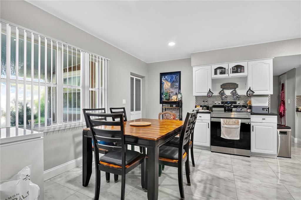 9727 Bear Lake Road Apopka, FL 32703 - Photo 11 of 22 a view of a dining room with furniture and chandelier