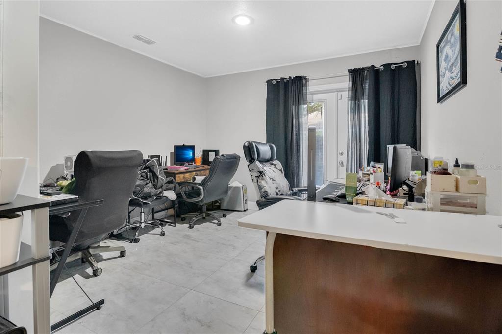 9727 Bear Lake Road Apopka, FL 32703 - Photo 14 of 22 a view of a workspace with furniture and a window