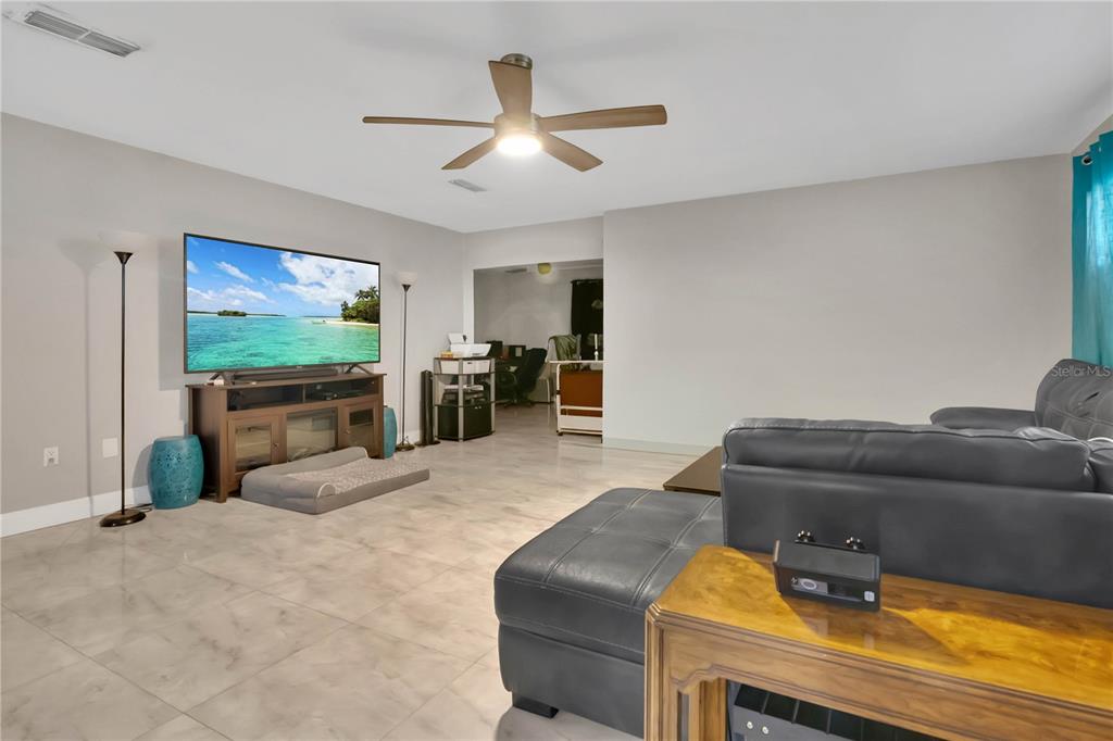 9727 Bear Lake Road Apopka, FL 32703 - Photo 3 of 22 a living room with furniture and a flat screen tv