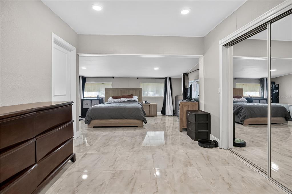 9727 Bear Lake Road Apopka, FL 32703 - Photo 7 of 22 a bedroom with furniture and a mirror