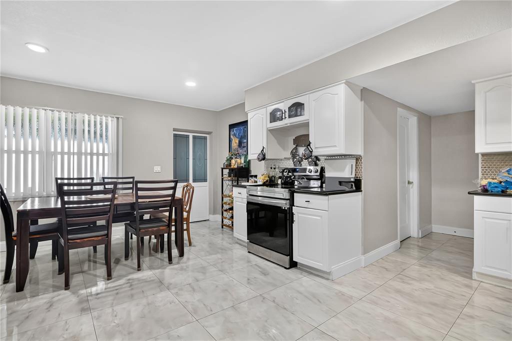 9727 Bear Lake Road Apopka, FL 32703 - Photo 10 of 22 a kitchen with a table and chairs in it