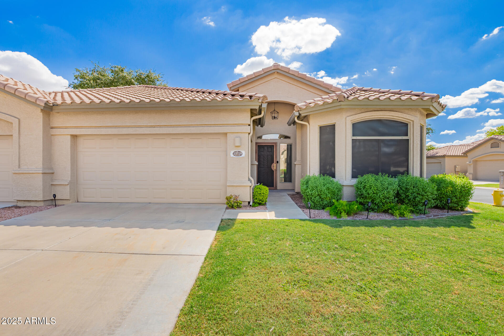 a front view of a house with garden