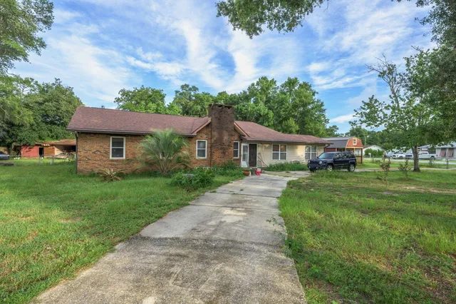 a front view of a house with a garden